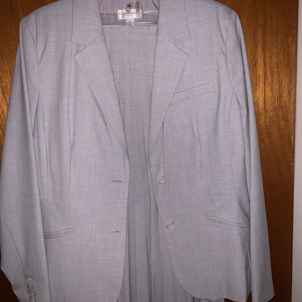 Light gray blazer with pleated knee length skirt